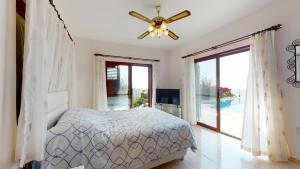 une chambre avec un lit et un ventilateur de plafond dans l'établissement Villa Tranquillity, à Kharcha 32 autres photos