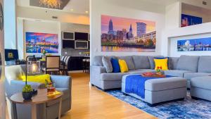 a living room with a couch and a table at Downtown Cleveland- Steps to Sports & Events condo in Cleveland