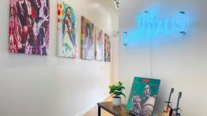 a room with four paintings on the wall at Downtown Cleveland- Steps to Sports & Events condo in Cleveland