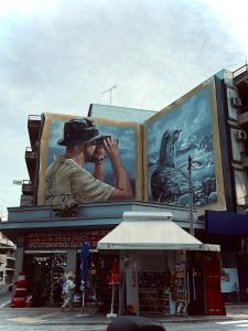 a man is taking a picture on a building at Chari's Apartment in Tríkala