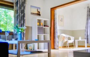 a living room with a table and a window at Amazing Home In Bjärtrå With Sauna in Bjärtrå