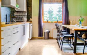 a kitchen with a table and chairs and a window at Amazing Home In Bjärtrå With Sauna in Bjärtrå