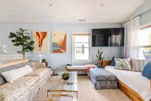 a living room with a couch and a table at Historic Belmont Home - Steps to Stowe Manor and Downtown in Belmont