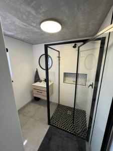 a bathroom with a shower with a glass door at Protea32 in Agulhas +16 photos