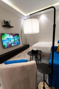 a room with a bed and a couch and a tv at A distinctive and upscale studio in Salamanca 112 in Riyadh