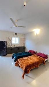 a bedroom with two beds in a room at Vivens Villas in Ooty