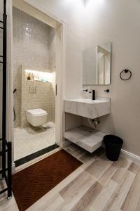 a bathroom with a sink and a toilet and a mirror at A distinctive and upscale studio in Salamanca 112 in Riyadh