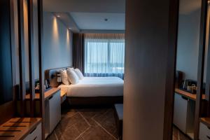 a hotel room with a bed and a window at Holiday Inn - Eindhoven Airport by IHG in Eindhoven +134 photos