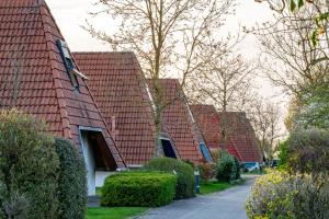 a row of houses with red roofs at Ferienhaus "Nanni" Wittsand 04 in Dorum-Neufeld