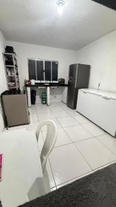 a kitchen with two refrigerators and a table and chairs at COP30 - Sitio em Benevides in Benevides