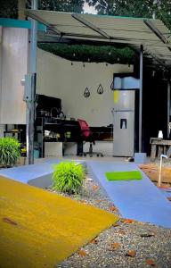 a parking lot with a gas station with plants at Sloth Glamping & Villas Fortuna in San Francisco