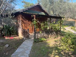 a small wooden building with vines growing on it at Kybele Nature Life in Edremit