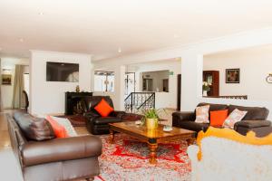 a living room with leather furniture and a coffee table at Miyanwe in Pretoria