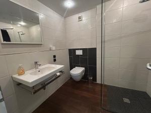 a bathroom with a sink and a toilet at Lounge 04 in Norderney
