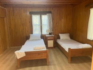 a bedroom with two beds and a desk and a window at Kybele Nature Life in Edremit +45 photos