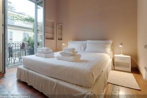 a bedroom with a large bed with towels on it at Brera Apartments in Duomo in Milan
