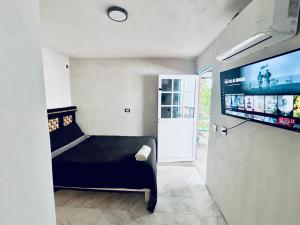 a room with a bed and a flat screen tv at Hotel Tropical in Villahermosa