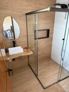 a bathroom with a shower with a sink and a mirror at Casa com visual deslumbrante in Carvalhos