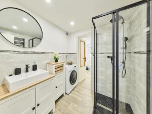a bathroom with a sink and a washing machine at Holiday Home Leisure Lounge & Pool by Interhome in Kvasiny