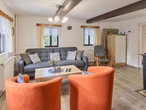 a living room with a couch and a table and chairs at Holiday Home Leisure Lounge & Pool by Interhome in Kvasiny