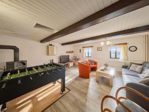 a living room with a foosball table in a living room at Holiday Home Leisure Lounge & Pool by Interhome in Kvasiny +43 photos