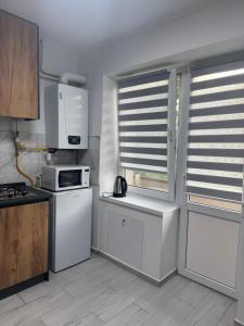 a kitchen with white appliances and a microwave at YarNika in Berehove