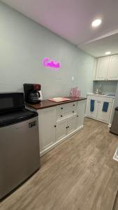 a kitchen with white cabinets and a counter top at Tropical Beach Studio Getaway B in Cocoa Beach