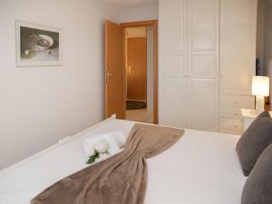 a white bed with a bouquet of flowers on it at Apartment Réze 5 by Interhome in Ovronnaz