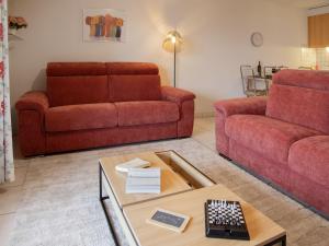 a living room with a couch and a table at Apartment Réze 5 by Interhome in Ovronnaz