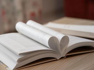 an open book sitting on a table at Apartment Réze 5 by Interhome in Ovronnaz