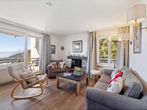 a living room with a couch and a table at Apartment Cransalpin Apt- 11 - Secteur 1 by Interhome in Vermala