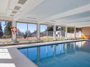 a swimming pool in a building with windows at Apartment Cransalpin Apt- 11 - Secteur 1 by Interhome in Vermala