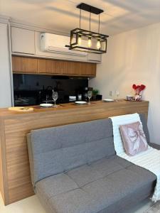 a living room with a couch and a kitchen at Apartamento Milla 1 in Pomerode
