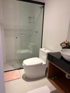 a bathroom with a shower and a toilet and a sink at Apartamento Milla 1 in Pomerode