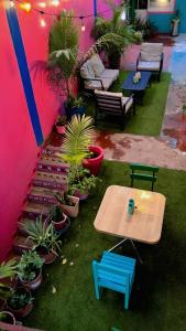 a patio with tables and chairs and potted plants at Hotel Tropical in Villahermosa