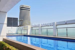 a swimming pool in front of a building at EcuOlimpo Lighthouse Stay double in Guayaquil