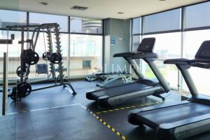 a gym with treadmills and ellipticals in a building at EcuOlimpo Lighthouse Stay double in Guayaquil