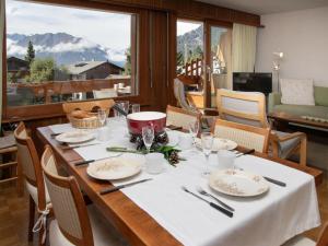a table with a white table cloth on it with a view at Apartment Val Neige 11 by Interhome in Verbier +23 photos