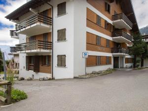 an apartment building with balconies and a parking lot at Apartment Galaxie 218 by Interhome in Verbier