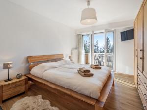 a bedroom with a bed with two towels on it at Apartment Vermala Soleil B1 by Interhome in Vermala