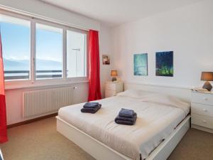 a bedroom with a bed with two towels on it at Apartment Armorial Est 72 by Interhome in Vermala