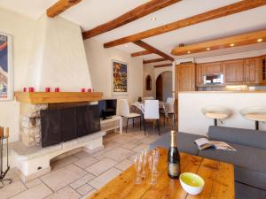 a living room with a fireplace and a table at Apartment Résidence Le Chalet 5 by Interhome in Crans-Montana