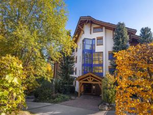 an exterior view of a building with trees at Apartment Résidence Le Chalet 5 by Interhome in Crans-Montana