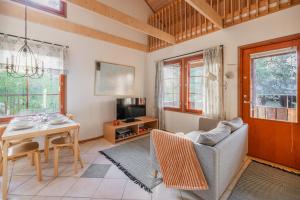 a living room with a couch and a table at Koda Halo Lodge - Sauna, Parking & Playstation in Rovaniemi