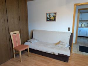 a living room with a couch and a chair at Ferienwohnung Lygri in Olpe