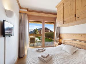 a bedroom with a bed with towels on it at Apartment Antares R05 by Interhome in Crans-Montana