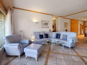 a living room with a couch and chairs and a table at Apartment Antares R05 by Interhome in Crans-Montana