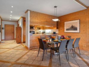 a kitchen and dining room with a table and chairs at Apartment Antares R05 by Interhome in Crans-Montana