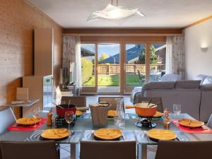 a living room with a table with chairs and a dining room at Apartment Antares R05 by Interhome in Crans-Montana +47 photos