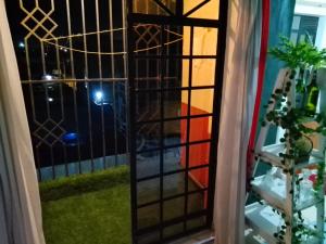 a door to a balcony with a view of a yard at Lovely one bedroom airbb in THIKA with WiFi ,ample parking-next to the road in Thika